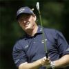 Ernie Els receives award in grey golf apparel