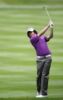 Rory McIlroy wears red golf apparel atop skyscraper