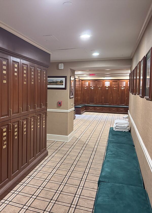 A wood panelled locker room with check carpet